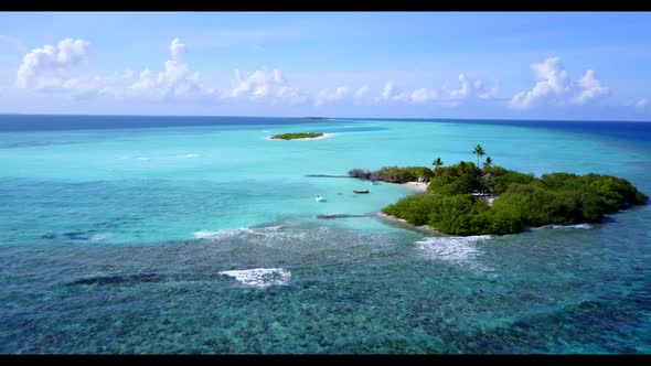 Aerial drone scenery of luxury tourist beach vacation by blue lagoon with white sandy background of 