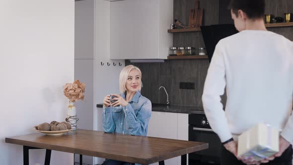 Young Attractive Guy Giving His Girlfriend a Gift