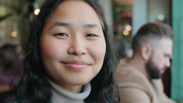 Portrait of Happy Asian Woman in Cafe