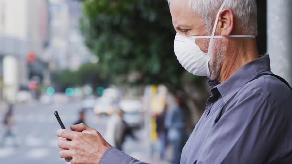 Caucasian man out and about in the street wearing on a face mask against coronavirus