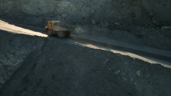 Mining truck is driving an opencast quarry.  Mining industry concept.