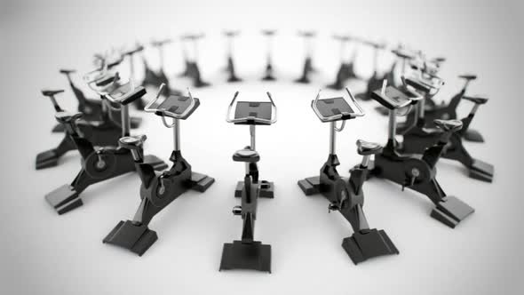 Gym equipment stationary bikes standing in the circular array. Loopable. HD