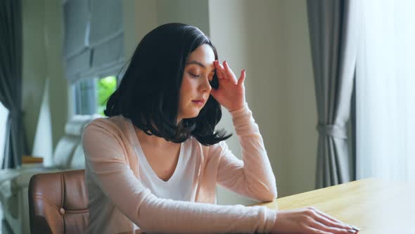 Homeschool Asian young woman student feeling bore from doing homework, assigned job at home.