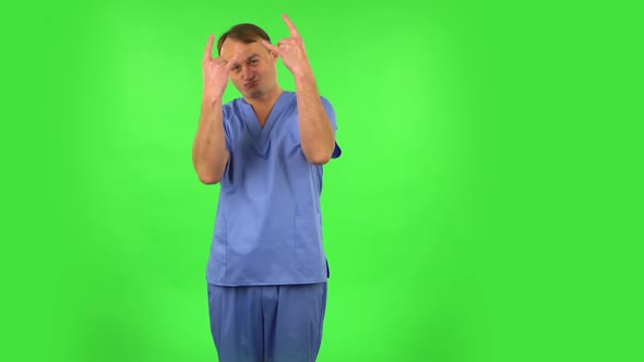 Medical Man Making a Rock Gesture, Enjoying Life and Laughing. Green Screen