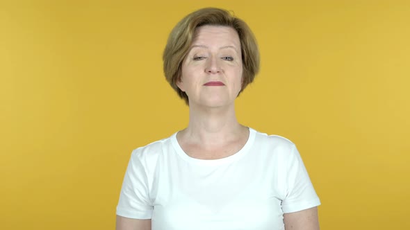 Yes, Old Woman Shaking Head To Accept Isolated on Yellow Background