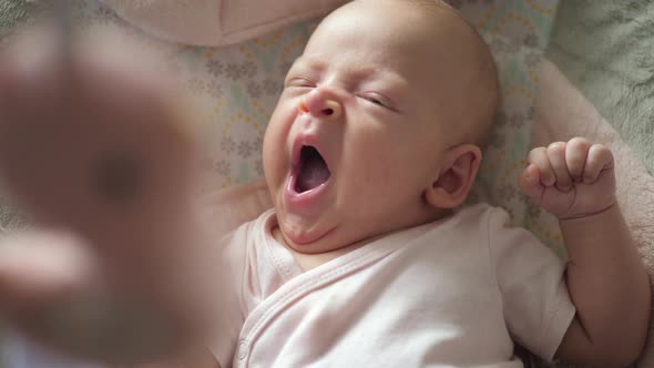 A slow motion of a yawning baby girl