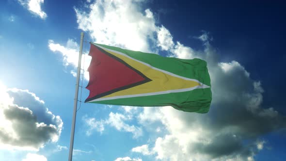 Flag of Guyana Waving at Wind Against Beautiful Blue Sky