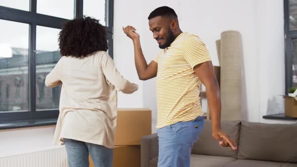 Happy Couple Moving To New Home and Dancing