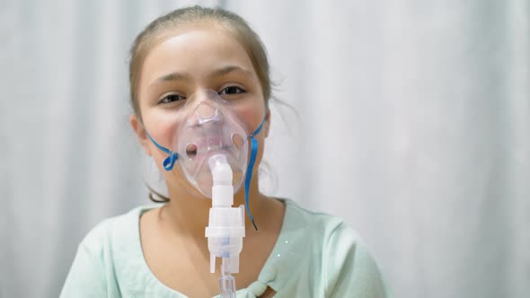 Teen Girl Inhaling Through Inhaler Mask