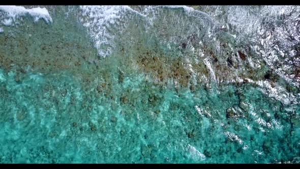 Aerial drone texture of tropical island beach voyage by shallow lagoon and white sandy background of