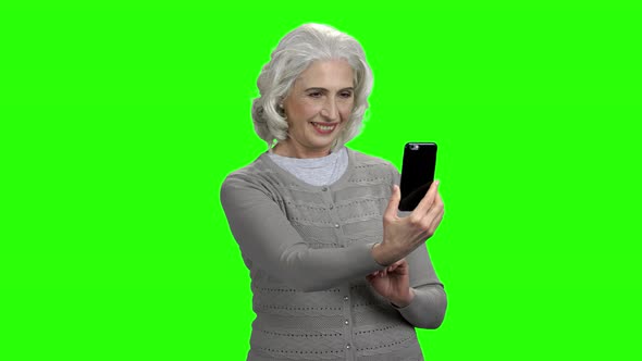 Old Woman Taking Selfie on Green Screen