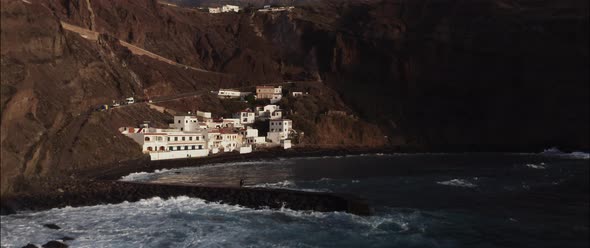 Drone shot of a white houses village by the sea