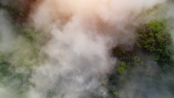 Drone flying above the clouds during sunrise