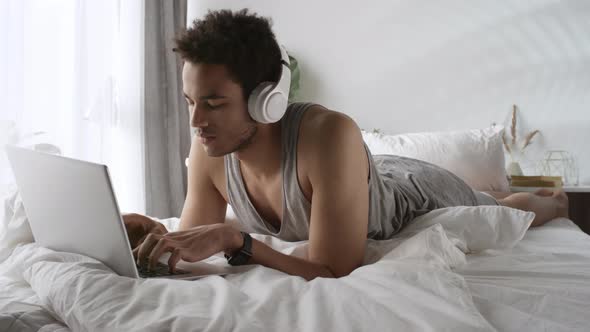 Black Man Watching Videos on Laptop