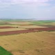 Wind turbines among the agricultural fields on the seashore. Aerial view. - VideoHive Item for Sale