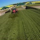 Copter flying around tractors in a silo on a farm - VideoHive Item for Sale