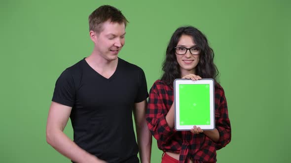 Young Couple Showing Digital Tablet Together