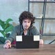 Young Curly Haired Man Using Laptop Computer with Headset to Talking Online - VideoHive Item for Sale