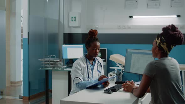 African American Doctor and Patient Doing Consultation