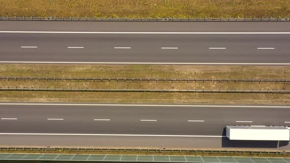 Traffic of cars and trucks on the Freeway in Summer day - top view shot. Top View shot of multi-lane