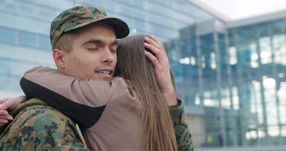 Close Up of Military Man Embracing Wife.