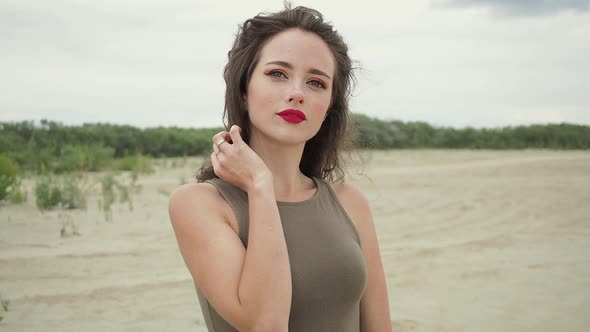 Pretty Woman Touching Hair on Beach