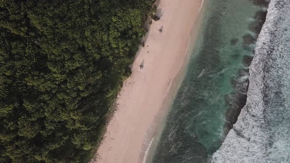 Aerial View of Tropical Beach with Azure Blue Water and Foaming Ocean Waves