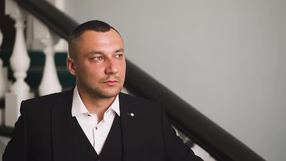 Gentleman in Black Costume and Shirt with Unbuttoned Collar