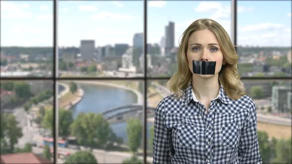 Pretty Caucasian Girl with Black Tape Over Mouth