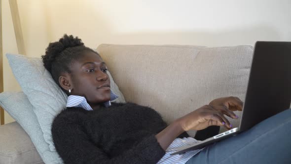 Woman Typing on Computer in Apartment