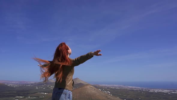 Woman Tourist Admires View From Mountain Top