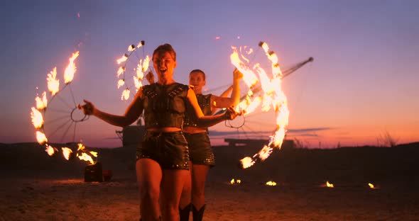 Professional Artists Show a Fire Show at a Summer Festival on the Sand in Slow Motion