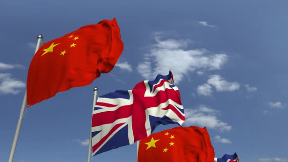 Waving Flags of Britain and China on Sky Background alt