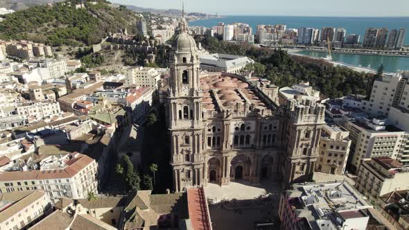 Malaga Cathedral facade with panorama city views, Aerial Orbiting. Andalusia. Spain