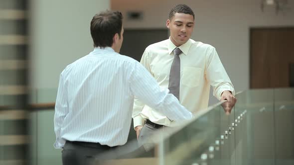 Businessmen shaking hands in office