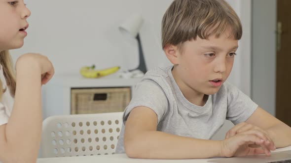 Brother Helps His Younger Sister to Make Her Homework