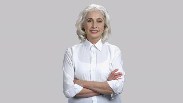 Portrait of Happy Old Senior Lady with Her Arms Crossed