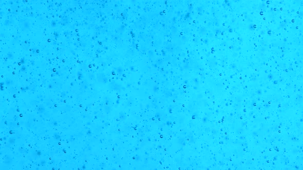 Moving Bubbles in a blue liquid, 4k footage