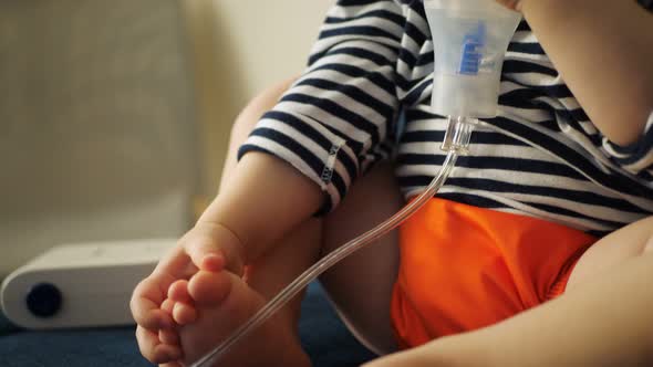 Sick Redhead Baby Girl Breathes in a Nebulizer