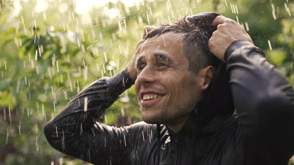 Cheerful Young Man Under Rain