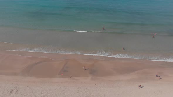 São Torpes beach and crystal clear waters seen from the sky.