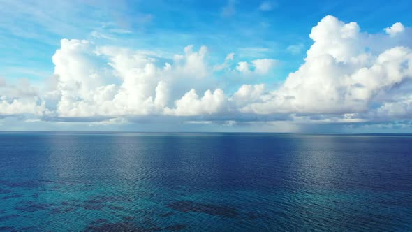 Aerial panorama of relaxing resort beach journey by blue water with clean sand background of a picni