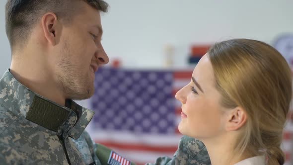 Loving American Soldier Hugging Young Wife Looking Camera