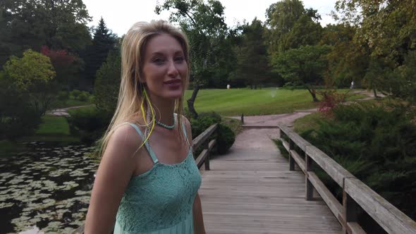 Young Caucasian Blonde Woman Walk In Park