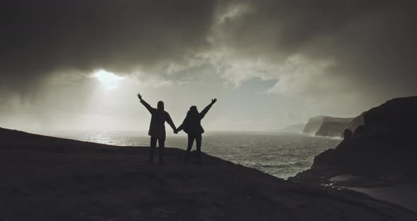 Couple shout from the top of mountain