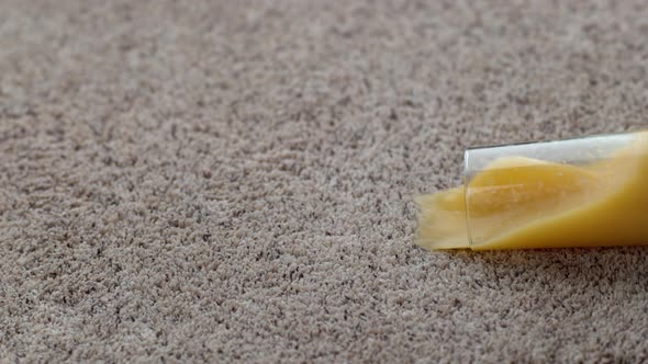 Glass of orange juice spilling on carpet in slow motion; shot on Phantom Flex 4K at 1000 fps alt