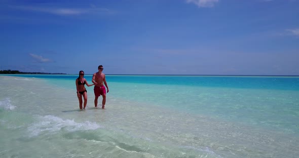 Young couple married on vacation enjoy luxury on beach on clean white sand background