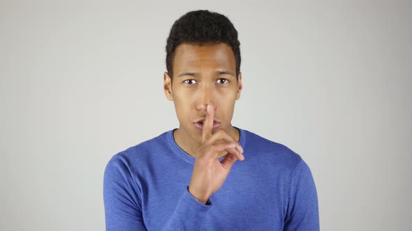 Silence Gesture By African Man White Background