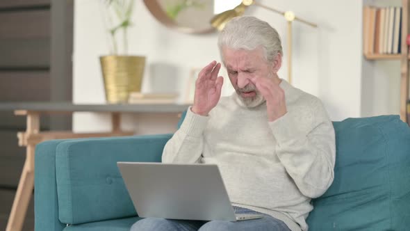 Old Man with Laptop Having Headache on Sofa
