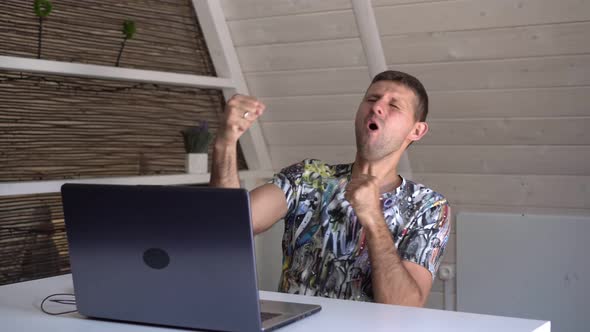 Happy Man with Laptop or Computer Emotionally Rejoices at Success